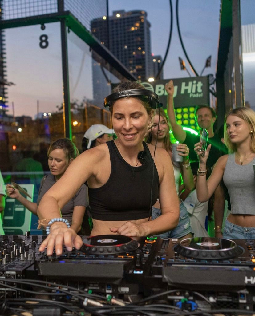 Smiling female DJ playing her decks