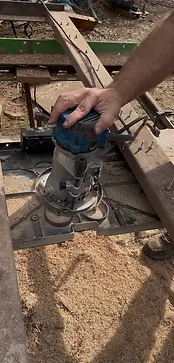 Hand operating a wood router for surface flattening