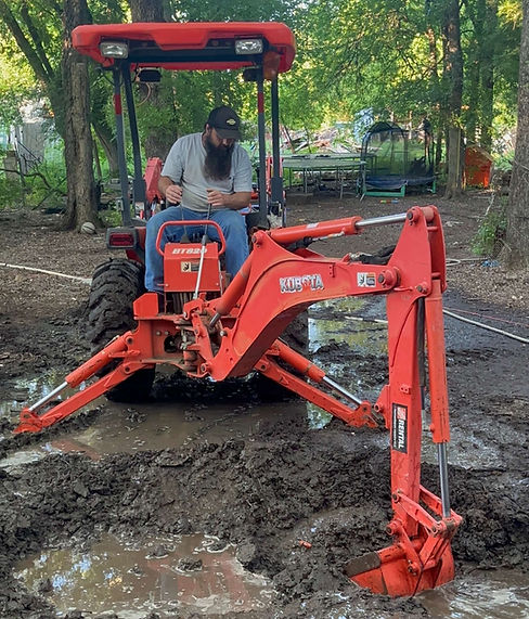 Man operating a backhoe for site excavation