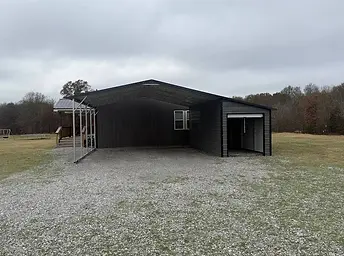 Large dark metal carport with attached storage unit in Weatherford, Tx.