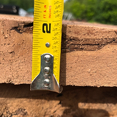Tape measure showing 2 inches on wood