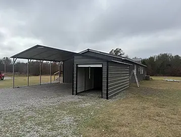 Metal carport with attached storage room providing covered parking and secure storage in Weatherford Texas.