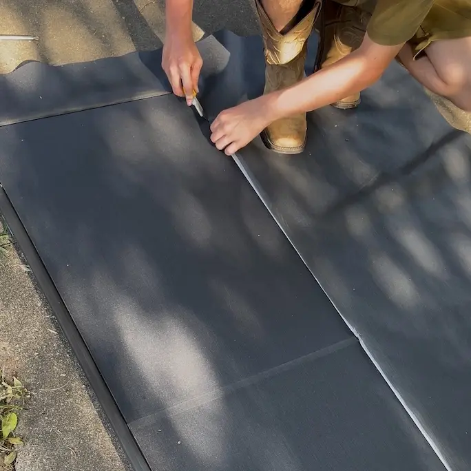 trimming newly installed solar screen