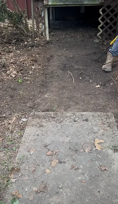 Dirt walkway leading to a wooden porch