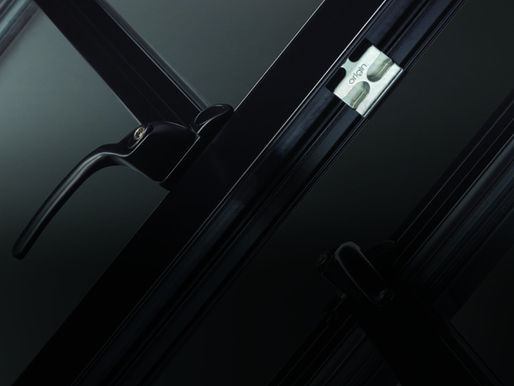 Window handle and hinge detail on a black frame