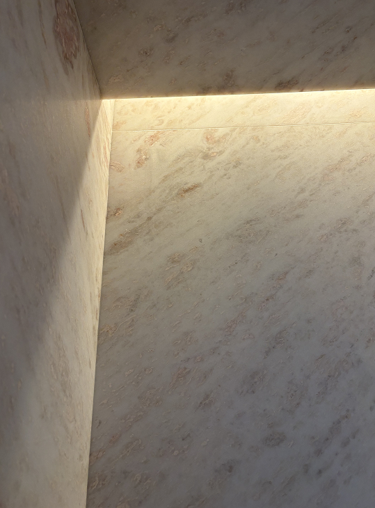 Back to the Future, a Lincoln Park, Chicago duplex renovation by Jaffe Architecture, features a fully marble-clad shower where stone wraps seamlessly from wall to ceiling, with a recessed light slot introducing a soft, ambient glow that elevates everyday living through thoughtful, precise detailing.