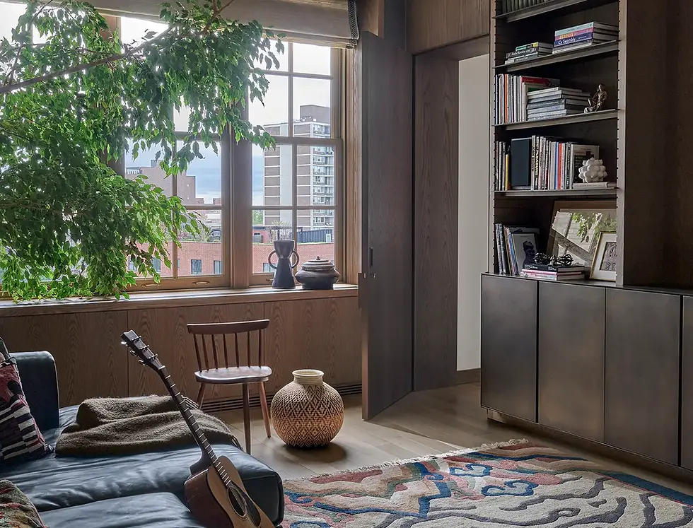 Back to the Future library in a Lincoln Park duplex renovation by Jaffe Architecture, featuring custom wood millwork, a flush paneled door concealing a hidden powder room, burnished brass cabinetry, and a warm, collected atmosphere shaped by the family’s everyday living