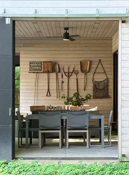 Pure Michigaas by Jaffe Architecture featuring a pool house that doubles as a screened porch, with warm wood cladding, sliding doors, and a relaxed indoor-outdoor gathering space designed for easy entertaining in Southwest Michigan
