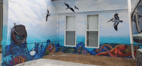 Coastal patio mural with pelicans and octopus painted around windows