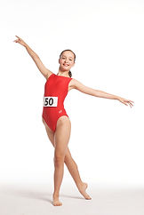 Girl in a red leotard dancing