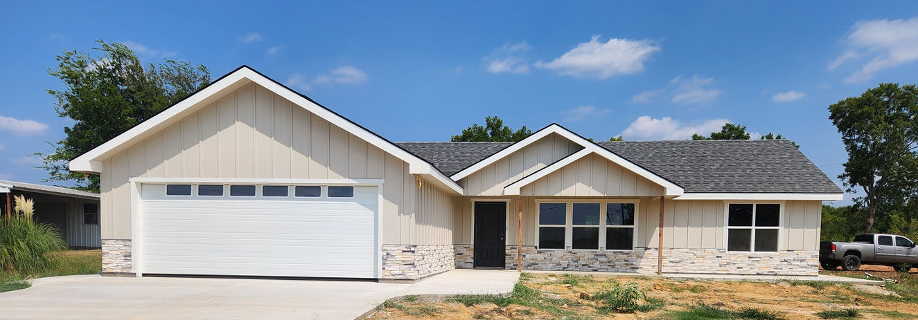 Simple, beige-colored house with Alpine Rustic Qwik Stack wainscoting.