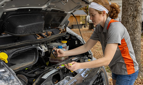 Female RV technician performing on-site RV maintenance and inspection services in Omaha, Nebraska