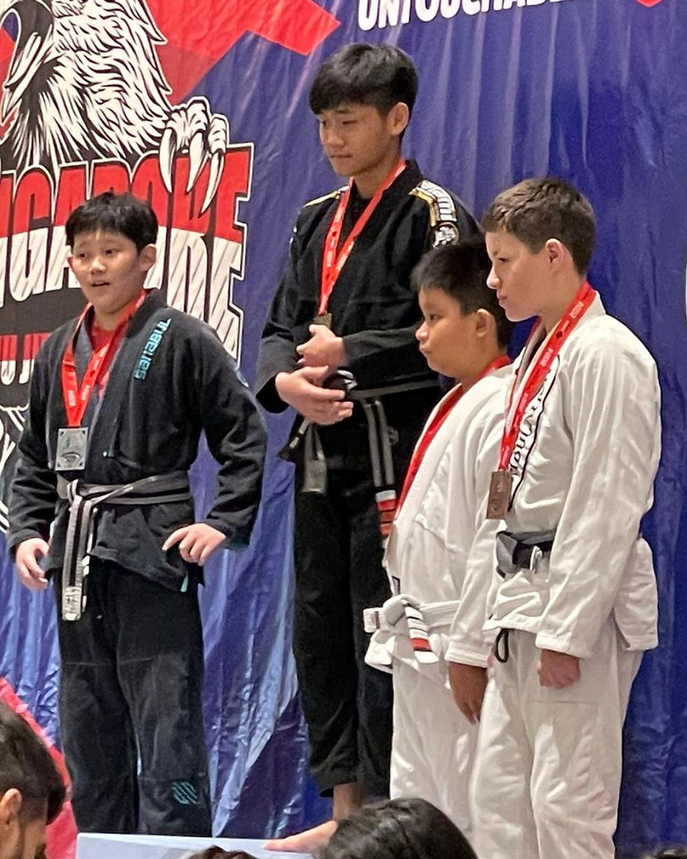 fama singapore brazilian jiu jitsu bjj kid on podium winning gold medal
