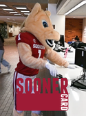 Boomer the mascot using his Sooner Card at the library. "Sooner Card"