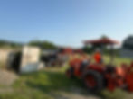 Worker using tractor for lawn care in Bath NY
