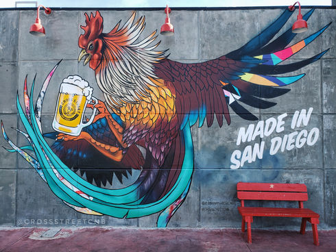 Rooster mural with text that says "Made in San Diego" on the outside wall of Cross Street Convoy 