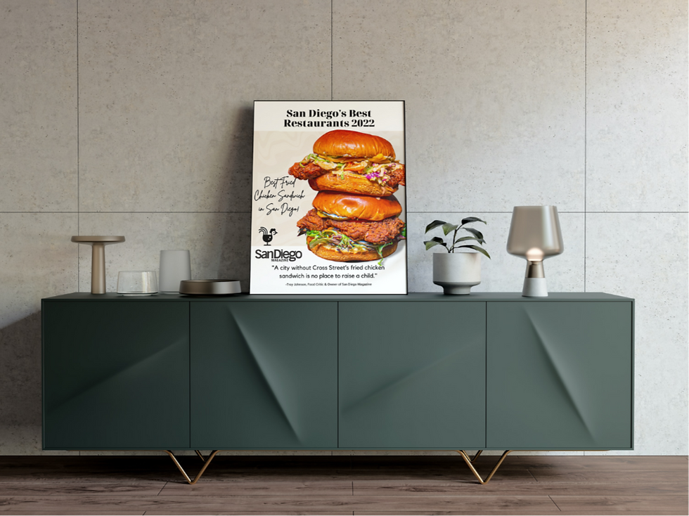 A graphic poster is framed and displayed on a cabinet