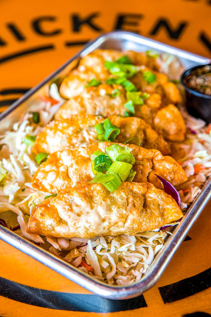 Fried dumplings with green onion garnish