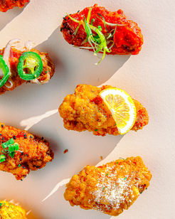 A variety of flavors of fried chicken wings