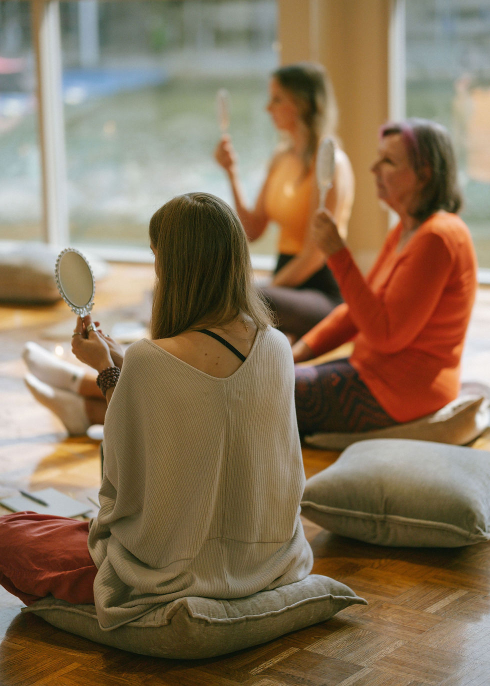 women in circle doing mirror work