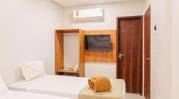 Quarto com cama na Pousada Antonella 13