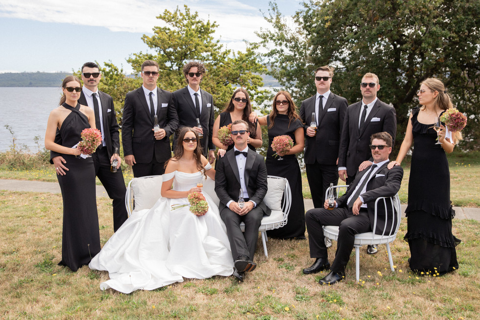 Bridal party sitting together posing seriously