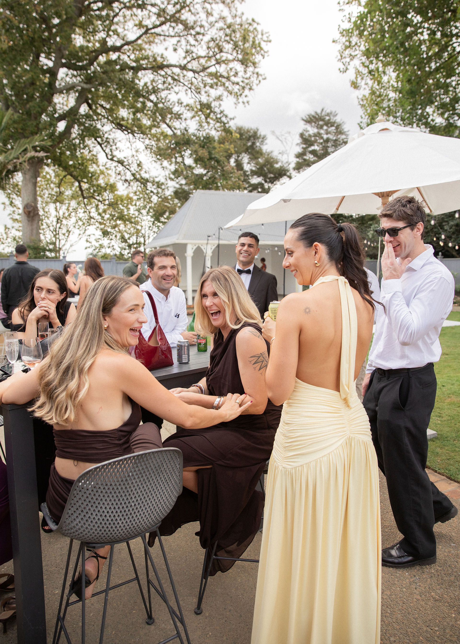 Wedding guests laugh together at wedding reception at Woodlands Estate, Waikato