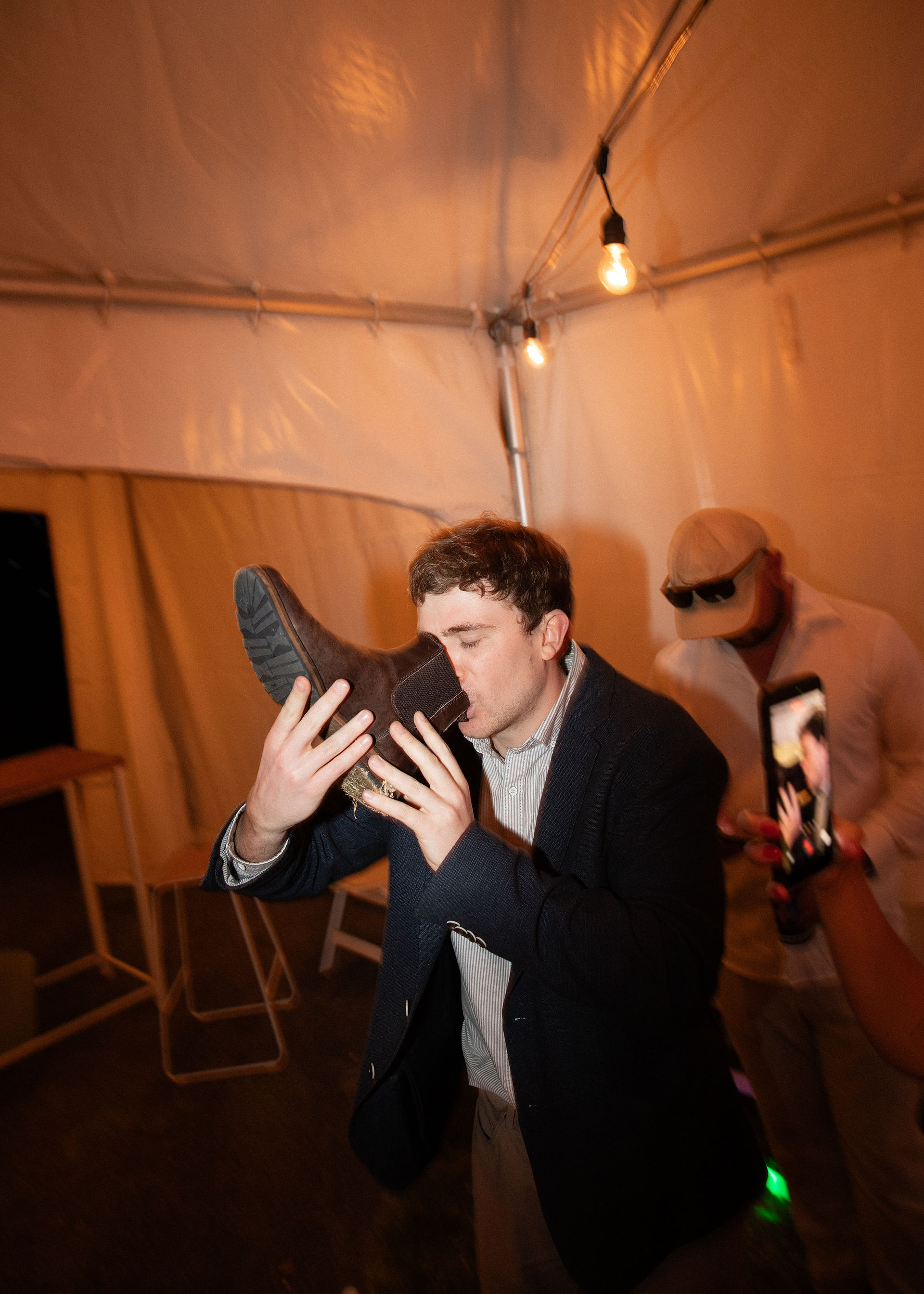 A wedding guest drinking from his shoe at a Waikato wedding