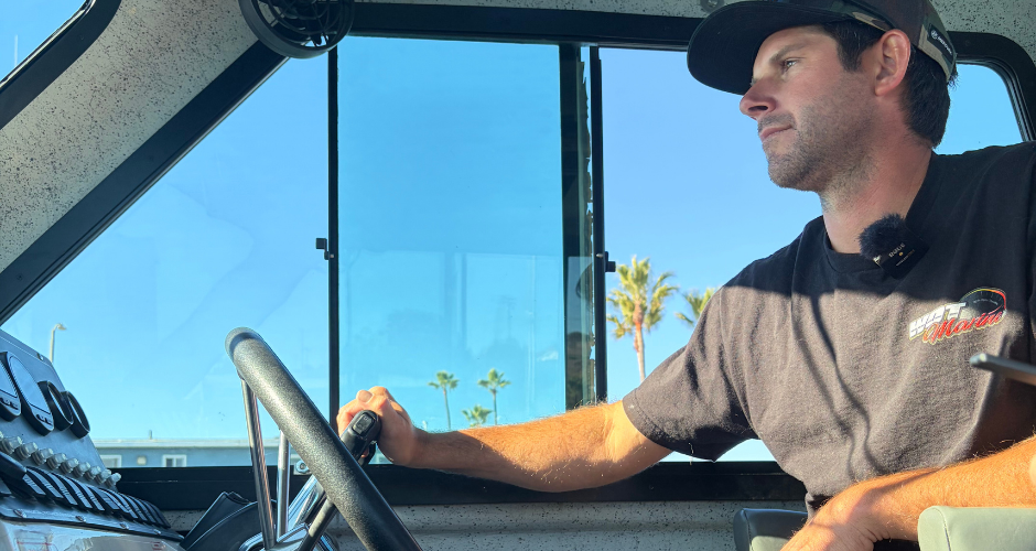 Certified marine technician operating a boat console, highlighting the benefits of partnering with a skilled professional for reliable marine service and maintenance.