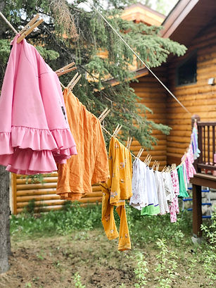 hanging girls laundry out to dry in Alaska summer