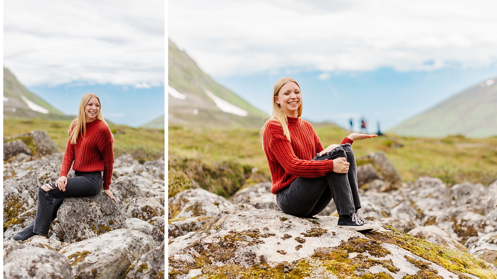 High school senior girl poses against a backdrop of mountains and tundra and laughs at hikers in the background.
