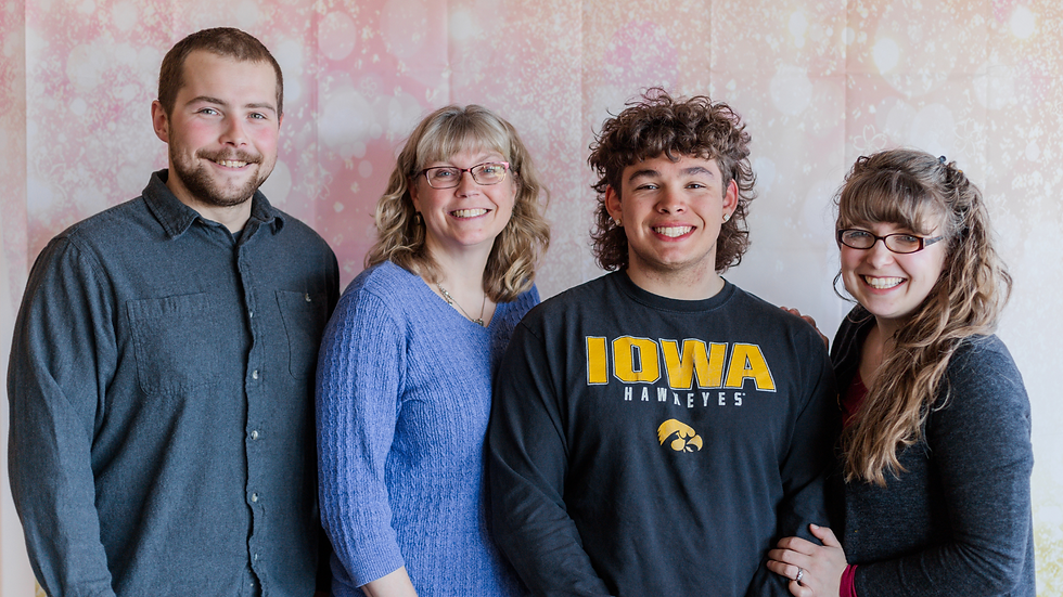 a mother and her children pose for a mother's day photo at church