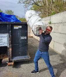 Man recycling boat shrink wrap