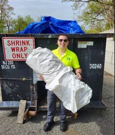 Man recycling boat shrink wrap 