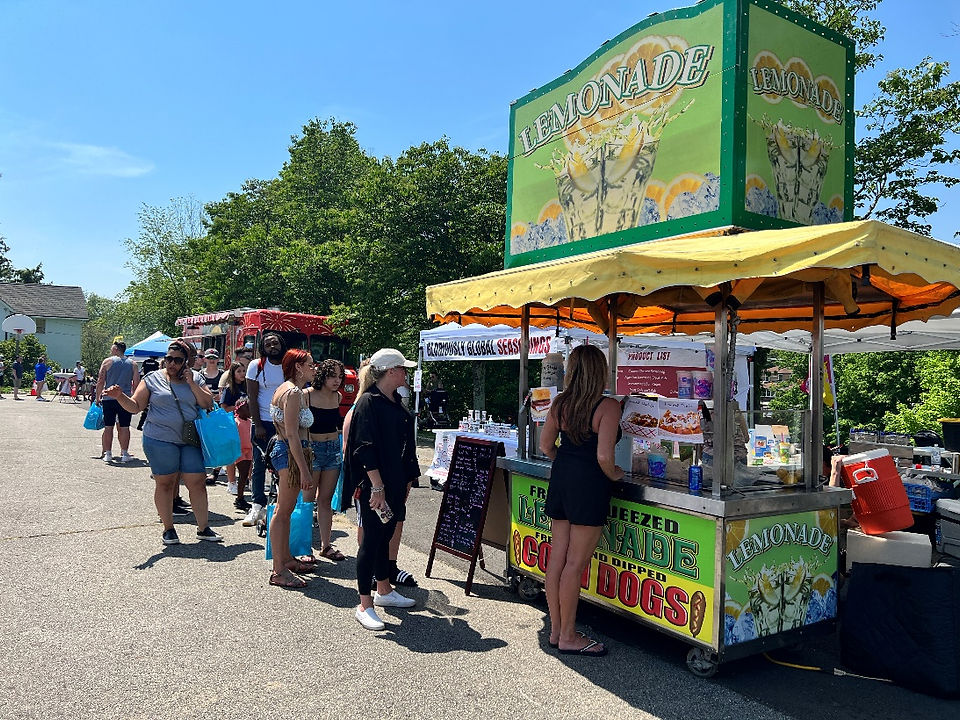 People waiting inline at a hotdog stand 