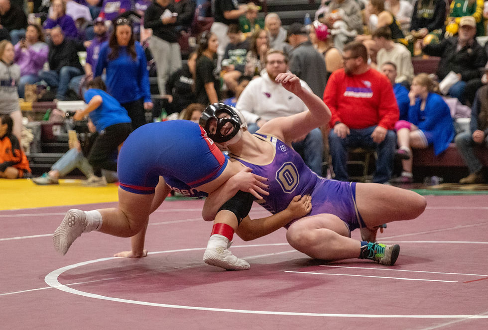 Oakley junior Cali Wagoner hits a switch against Russell’s Ashlynn Henley.