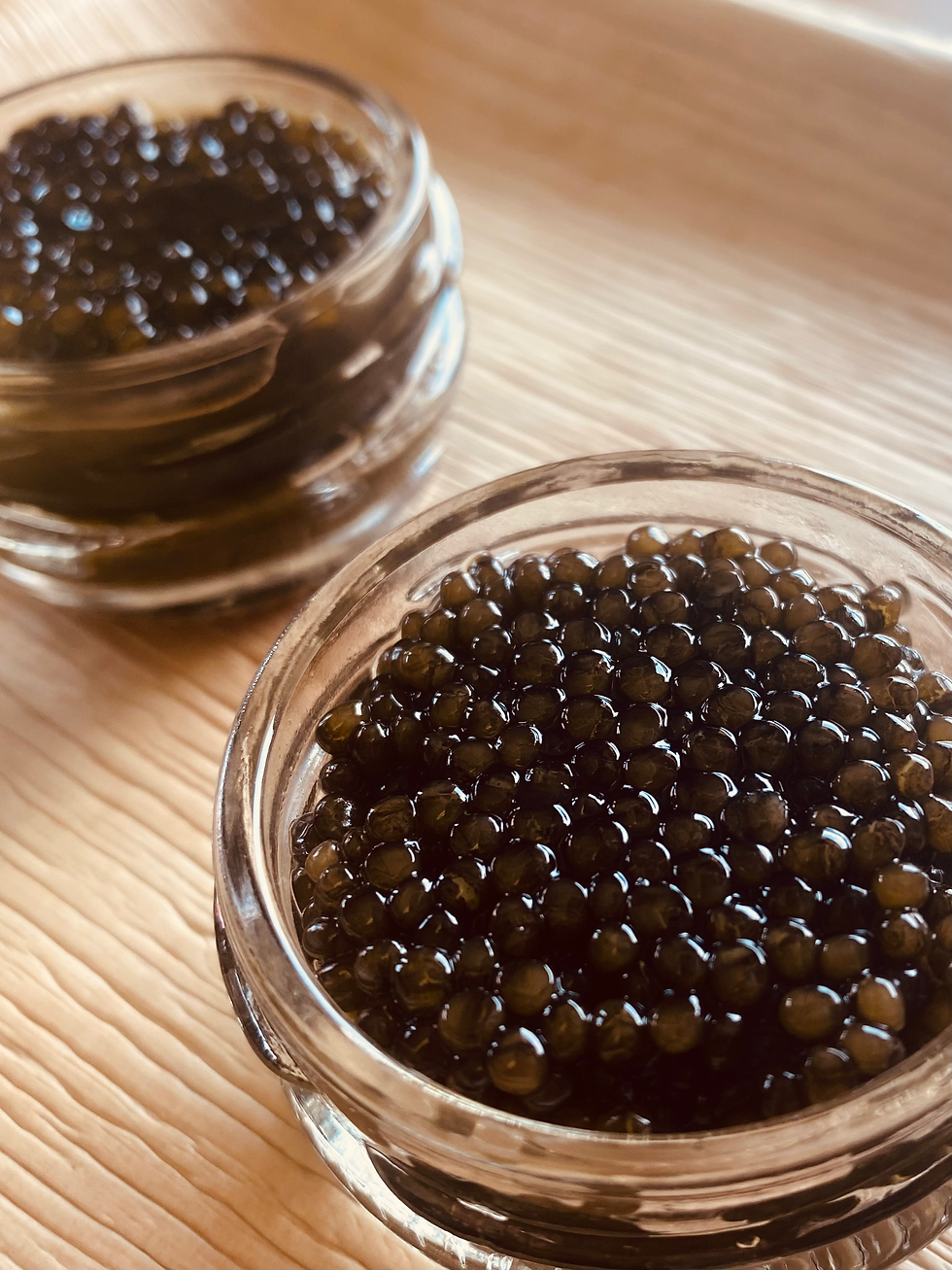 dark brown caviar in glass bowl