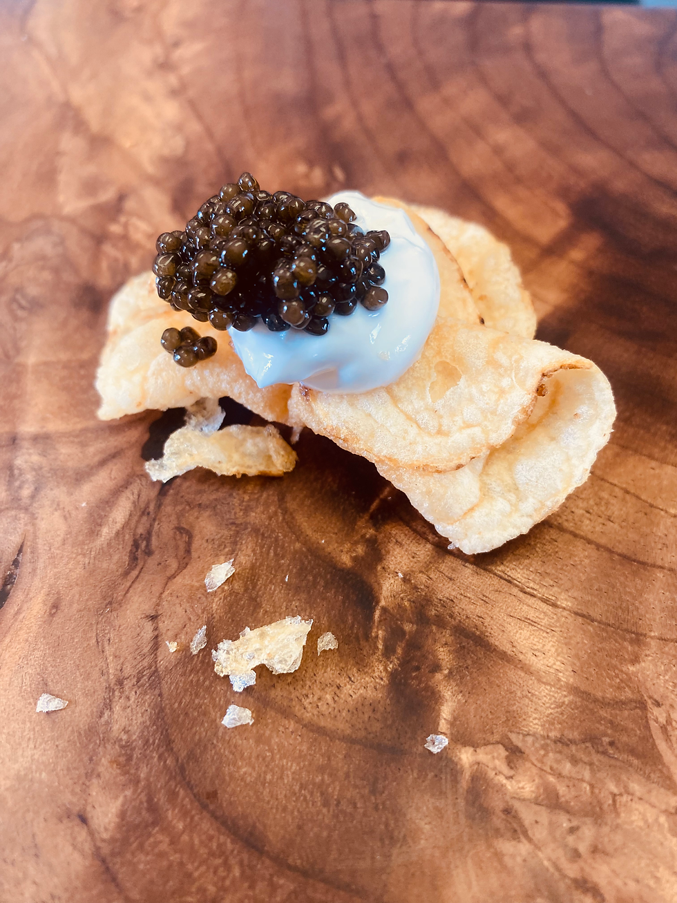 caviar on top of creme fraiche and potato chip