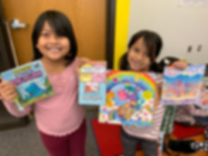 Students showing of books they selected.