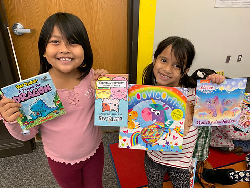 Students showing of books they selected.