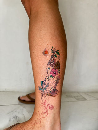Colorful Costa Rica nature tattoo featuring a sloth, volcano, hibiscus flower, and tropical scenery created at White Sloth Tattoo Shop in Tamarindo.