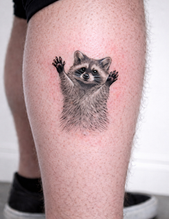Realism raccoon tattoo with detailed fur and expressive eyes created at White Sloth Tattoo Studio in Tamarindo, Costa Rica.