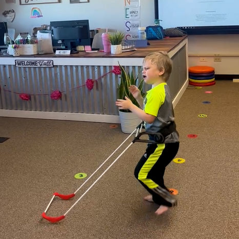 4-year-old boy walks through his classroom wearing a belt cane
