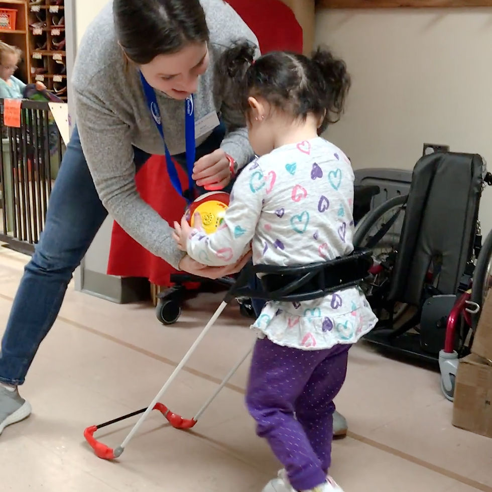 4-year-old girl gives a ball to her teacher walking wearing her belt cane