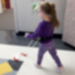 Close-up view of a pediatric belt cane attached to a child’s waist