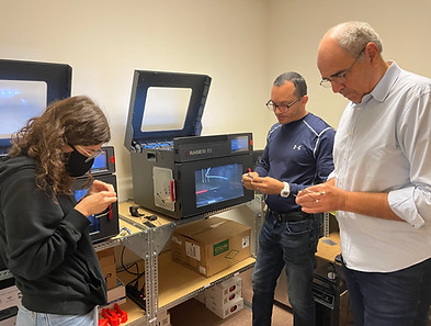 a safe toddles engineer and technicians working in the 3D printer room.