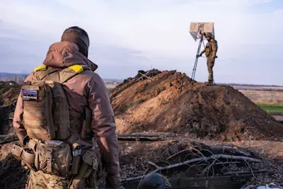 A drone team of the Ukrainian army setting up equipment in former Russian trenches.