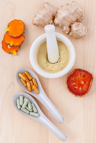 herbs, pills and grinder