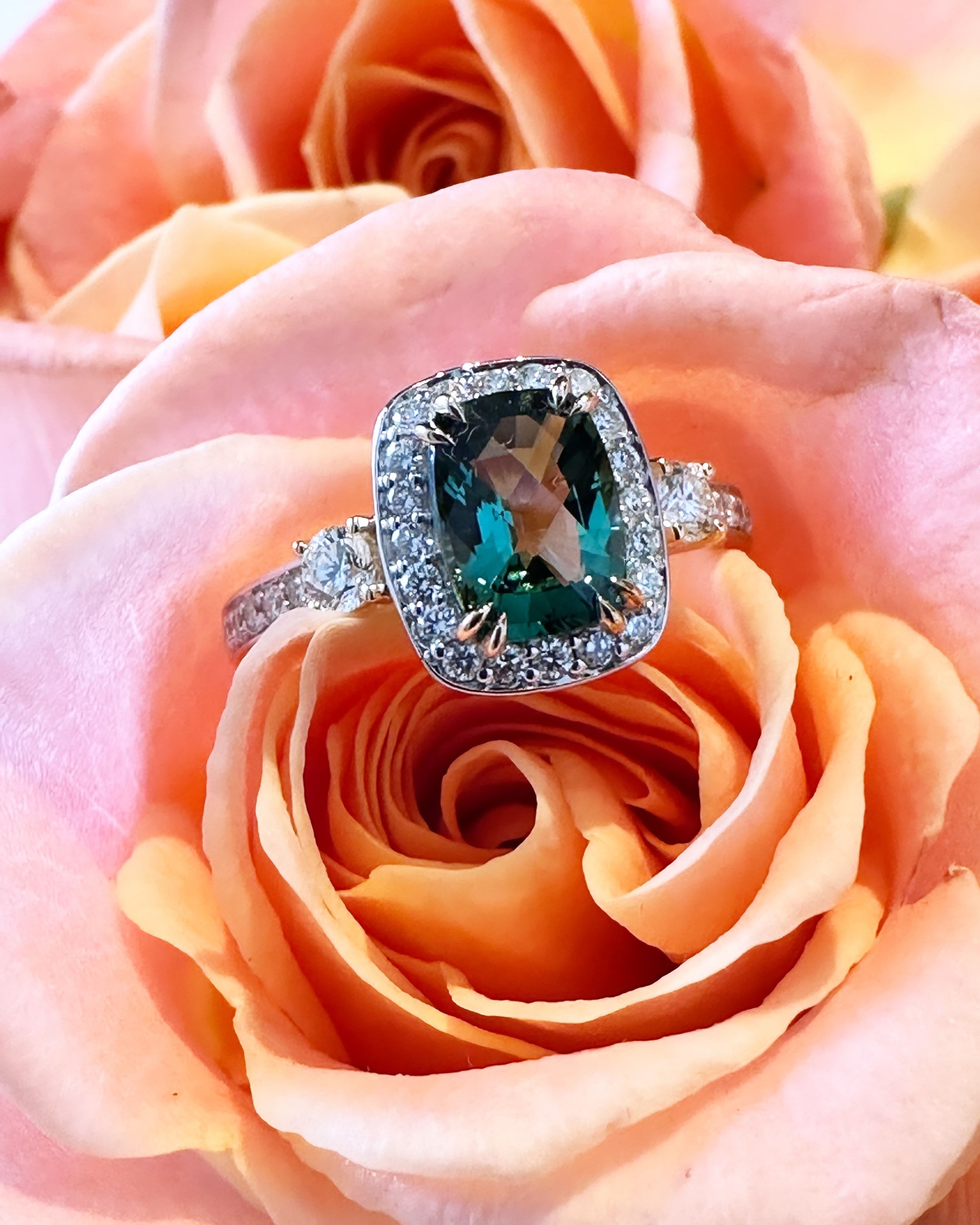 A Rich Green Tourmaline and Diamond Halo Ring
