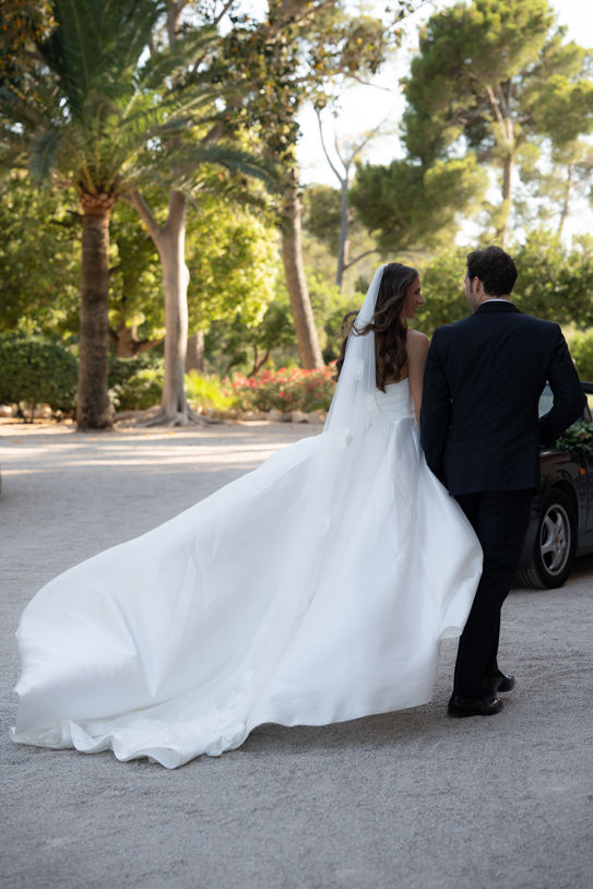 Bride walking with flowing wedding dress at Castillo de Bendinat.